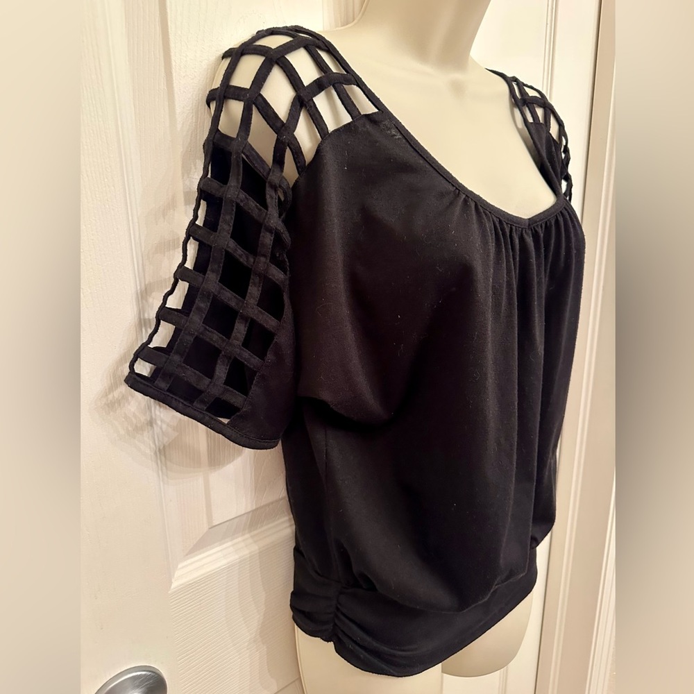Black shirt with shoulder cut outs.